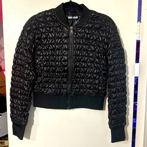 NWOT. Woman’s DKNY Jeans black cropped puffer jacket. Size S.